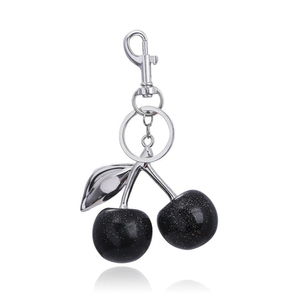 Kersen sleutelhanger dames – glanzend accessoire met gouden details en rode glitterkersen